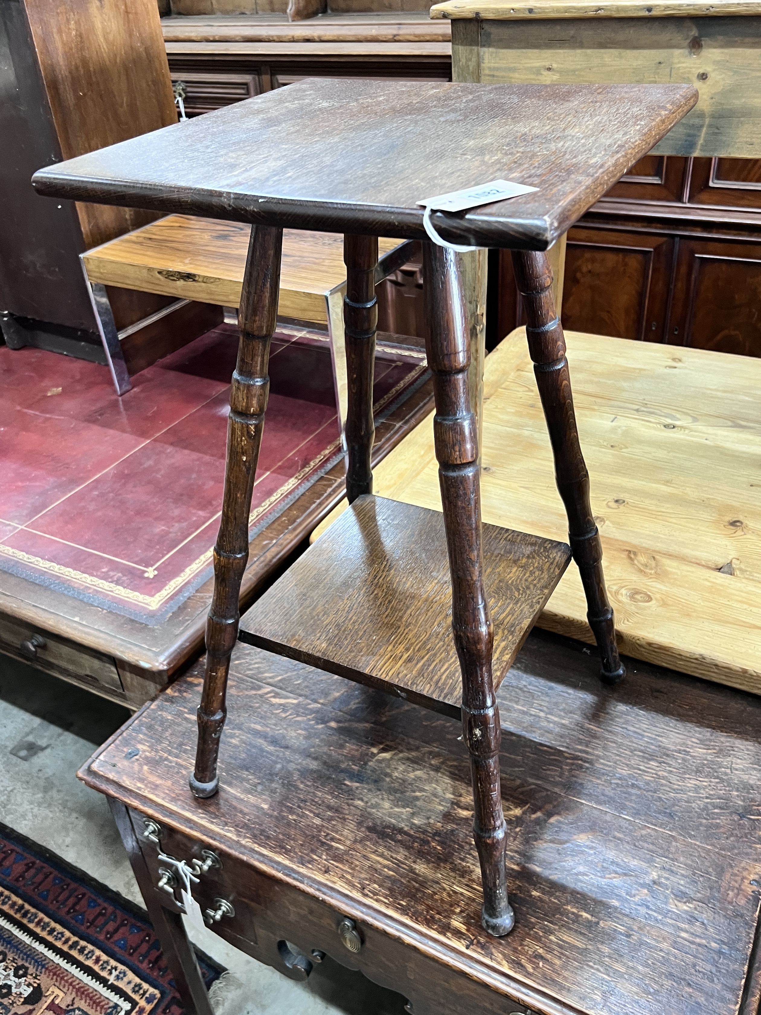 An early 20th century two tier oak occasional table, width 40cm, height 72cm